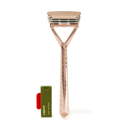 leaf razor in rose gold with a small pack of razors in a green box