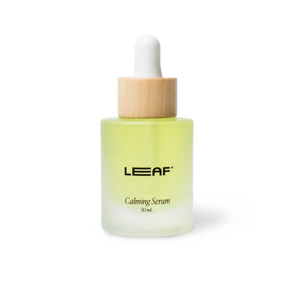 leaf calming serum in a glass bottle with a dropper with wood