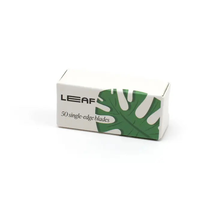 A compact white box labeled Leaf Razor Accessories by Leaf, featuring a green leaf graphic and text indicating 50 single edge blades—ideal for your safety razor.