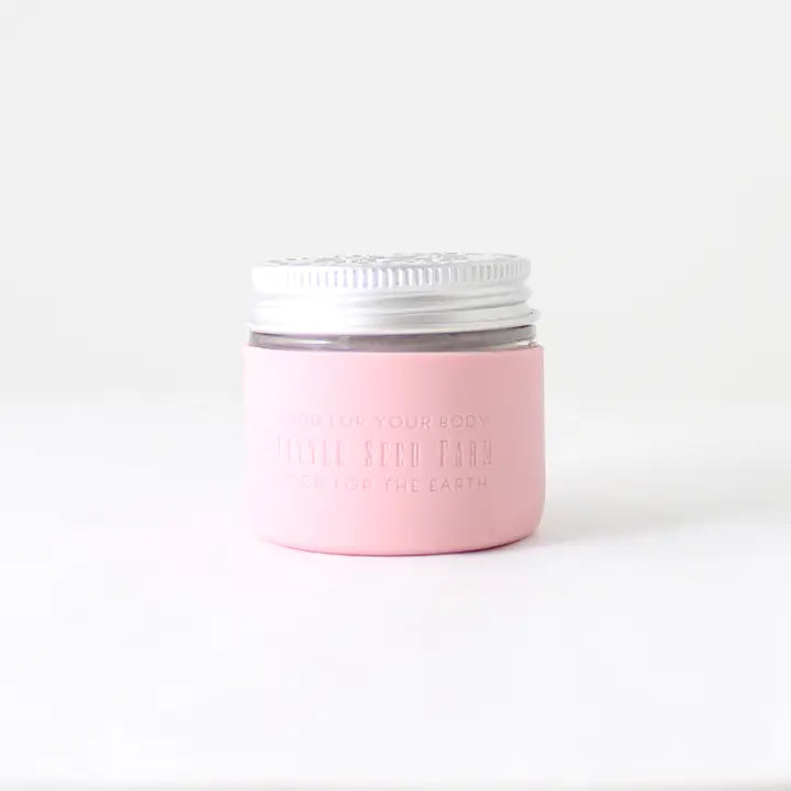 A Protective Silicone Sleeve from Little Seed Farm rests on a white surface with a plain background—a sustainable and stylish alternative for storage.