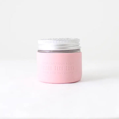 A Protective Silicone Sleeve from Little Seed Farm rests on a white surface with a plain background—a sustainable and stylish alternative for storage.