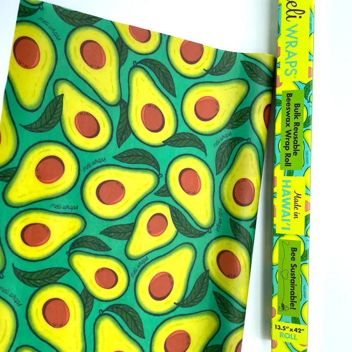 beeswax wrap roll. green with the inside of avocados as the print.