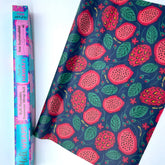 The Meli Wraps Beeswax Roll by Meli Wraps features a dark background with a vibrant strawberry and leaf pattern, shown beside its colorful packaging highlighting eco-friendly food storage and product details.