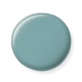 Round teal nail polish sample  on a white background