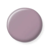 Round purple nail polish sample on a white background