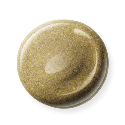 Round, gold nail polish sample on a white background