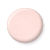 Round pink nail polish sample on a white background