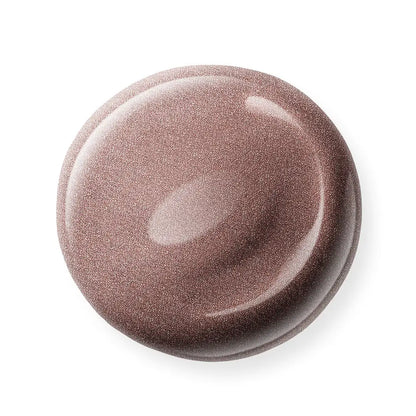Round, brown nail polish sample on a white background