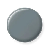 Round gray nail polish sample on a white background