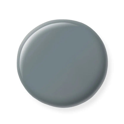 Round gray nail polish sample on a white background