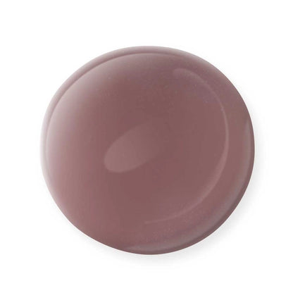 A glossy, round droplet of Mineral Fusion Nail Polish by Mineral Fusion in a rich mauve shade rests on a white background, highlighting the appeal of this non-toxic, clean beauty favorite.