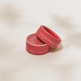 A pink Minori Mini Cream Blush and Highlighter in a round container, its lid angled. The soft beige packaging reads “Cream Blush” and “Vegan | Cruelty-free”—ideal for sustainable beauty routines.
