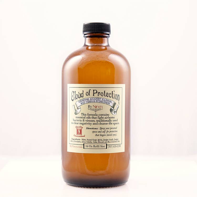 Bulk Cloud of Protection by Nieves is an eco-friendly brown glass bottle with a black cap, featuring antimicrobial essential oils to clear negativity. This spray also acts as a hand sanitizer and is shown against a white background.