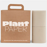 A Plant Paper box sits next to two beige rolls of Plant Paper Toilet Paper. The packaging notes this tree-free toilet paper from Plant Paper is bleach-free and formaldehyde-free.