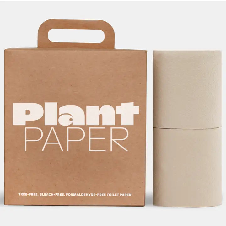 A Plant Paper box sits next to two beige rolls of Plant Paper Toilet Paper. The packaging notes this tree-free toilet paper from Plant Paper is bleach-free and formaldehyde-free.