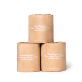 Three rolls of Plant Paper Toilet Paper by Plant Paper, wrapped in brown paper labeled "Tree-free, Toxin-free Toilet Paper," are stacked in a pyramid on a white background.