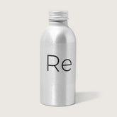 A compact silver metallic bottle with a screw cap, featuring "Re" in black on the front, holds Rebrand’s Foresight Sunscreen SPF 30—mineral sunscreen for face—shown against a plain light background.