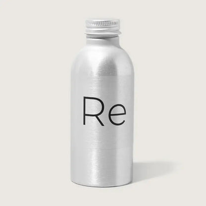 A compact silver metallic bottle with a screw cap, featuring "Re" in black on the front, holds Rebrand’s Foresight Sunscreen SPF 30—mineral sunscreen for face—shown against a plain light background.