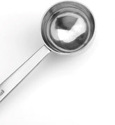 A close-up of the Refill Mercantile Tablespoon Measuring Spoon, made of shiny stainless steel with a flat handle, ideal for precise food-grade measurements, placed on a white background.