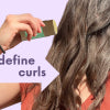 picture of person wiping hair wax on curls to define curls