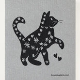 The Cats and Dogs Swedish Dishcloth by Three Bluebirds Swedish Dishcloths features a black cat silhouette with white hearts and flowers on a light gray background. Biodegradable & eco-friendly.