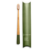 The Truthbrush - Bamboo Toothbrush by Truthbrush features light bristles and a green handle, pictured beside its matching green, rectangular case labeled "Truthbrush beautiful bamboo toothbrush.