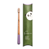 The Truthbrush - Bamboo Toothbrush by Truthbrush features a vegan purple bamboo handle and bristles, shown beside a green box with a panda illustration and the text "tiny truthbrush, beautiful bamboo toothbrush.