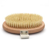 The Zefiro Dry Brush features a round wooden body, dense natural bristles, and a fabric hand strap with two metal rivets—ideal for exfoliation. Shown here on a white background.