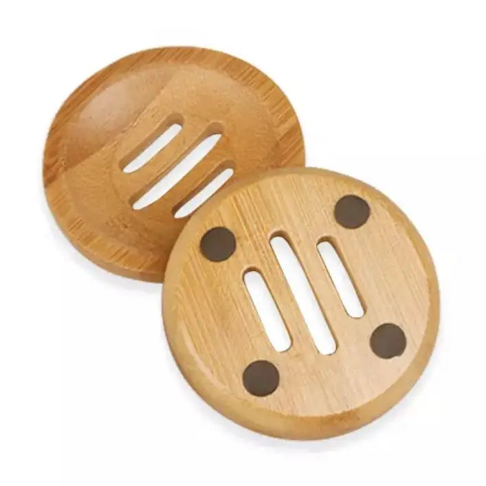 Two wooden soap dishes with slotted design on a white background