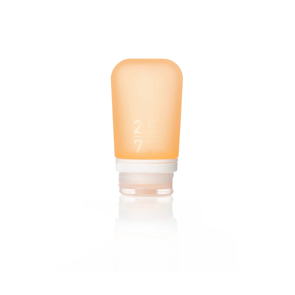 The Humangear GoToob+ is a small, soft orange silicone bottle with a white screw-on cap. Marked 2.5 and 7, it stands upright—perfect as a leak-proof, refillable toiletry travel container.
