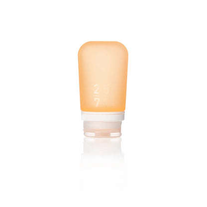 The Humangear GoToob+ is a small, soft orange silicone bottle with a white screw-on cap. Marked 2.5 and 7, it stands upright—perfect as a leak-proof, refillable toiletry travel container.