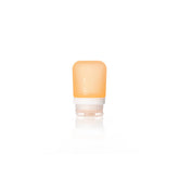 The Humangear GoToob+ is a small, translucent orange silicone travel bottle with a white cap and faint measurement markings. This leak-proof, refillable toiletry container stands upright on a white background.