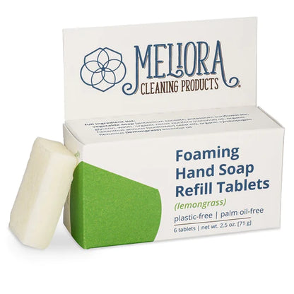 A box of Meliora Foaming Hand Soap Tablets (lemongrass), labeled plastic-free and palm oil-free, with one white concentrated tablet leaning against the box.