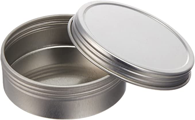 The Steel Tin by Refill Mercantile is a small, round, empty shallow container with a smooth surface and a matching screw-on lid. Perfect for storing balms or samples.