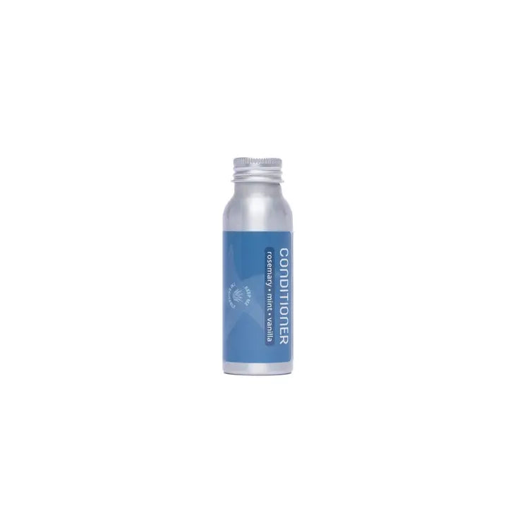 A silver, refillable aluminum bottle with a blue label and silver cap, labeled “Plaine Products Conditioner,” stands upright against a plain white background.