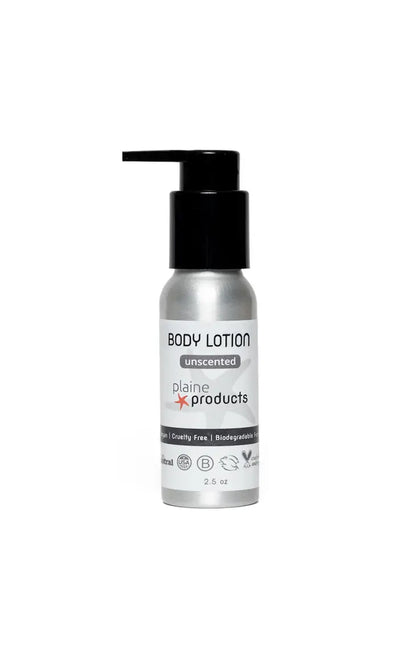 A 2.5 oz silver Plaine Products Lotion bottle with black pump, labeled “unscented,” “cruelty free,” and “biodegradable.” Plastic-free, refillable travel size by Plaine Products, featuring a minimalist design on a white background.