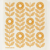 The Sunflowers Swedish Dishcloth by Three Bluebirds Swedish Dishcloths features stylized orange sunflowers with round centers and pairs of leaves in vertical rows on a cream background—adding charm to any eco-friendly, biodegradable cleaning cloth.